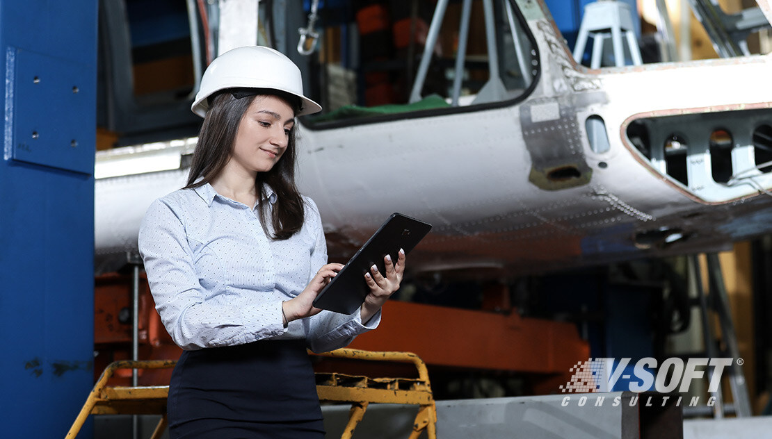 Woman in manufacturing holding a tablet