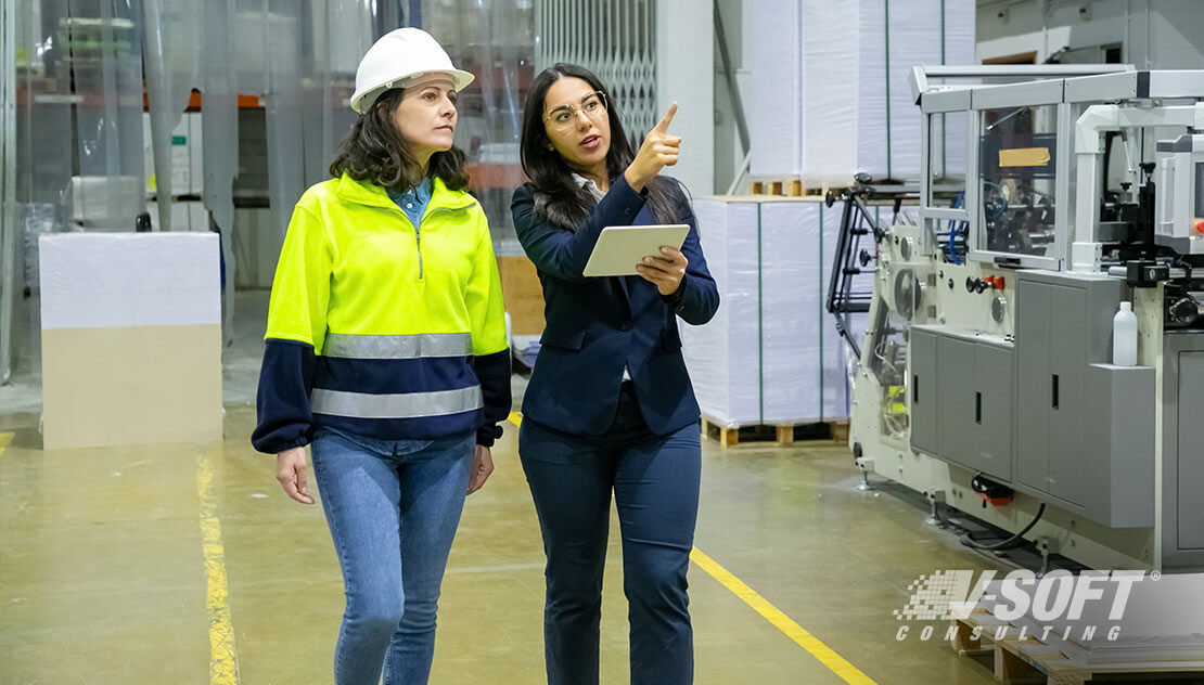 Industrial engineering manager pointing at the manufacturing machines